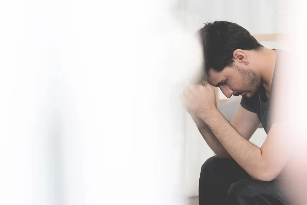 A man resting his head on his fists | grief counselor san francisco | loss and grief treatment san francisco | therapist for grief san francisco | 94539 | 94110 | 94112