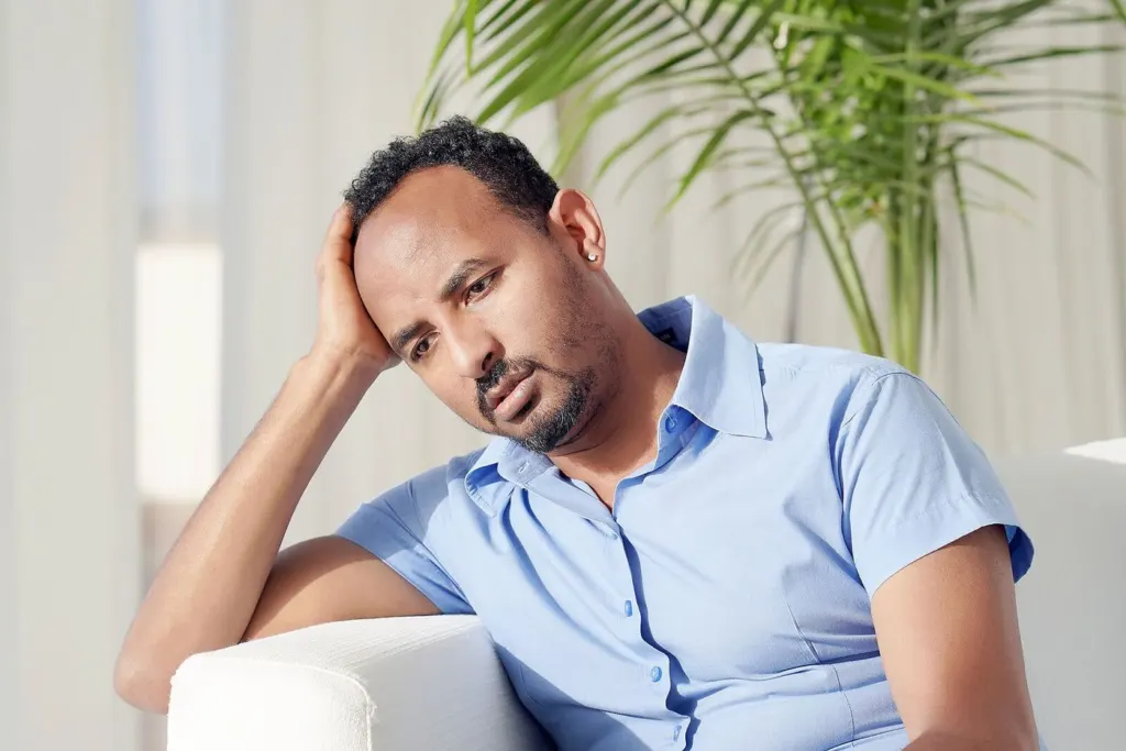 A man holding his head in his hands, showing emotions | grief therapist in san francisco, ca | grief therapy in san francisco, ca | grief counseling san francisco, ca | 94110 | 94112 | 94116