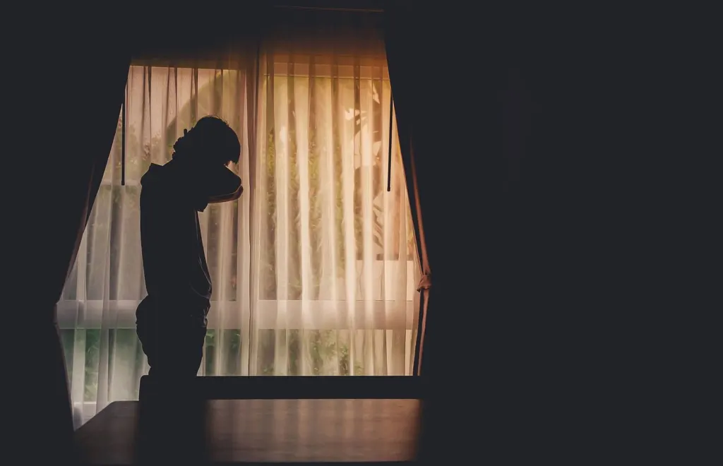 A man standing alone in front of a large window | grief counseling san francisco, ca | grief therapist in san francisco, ca | grief therapy in san francisco, ca | 94609 | 94061 | 94941
