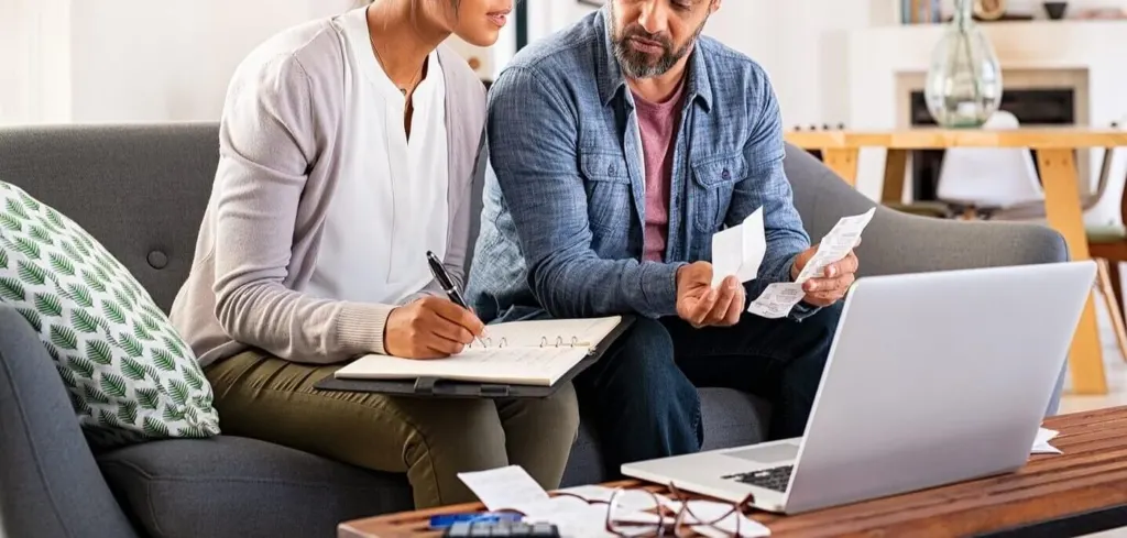 A couple going through finances together on the couch | grief counselor san francisco, ca | grief counseling san francisco | grief therapy in san francisco, ca | 94121 | 94607 | 94608