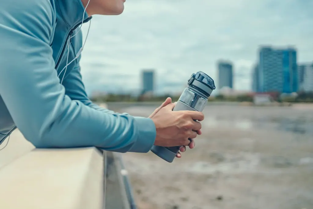 A man holding a water bottle while looking at the ocean | bereavement counseling in san francisco, ca | grief therapy san Francisco | grief counseling san francisco, ca | 94609 | 94061 | 94941