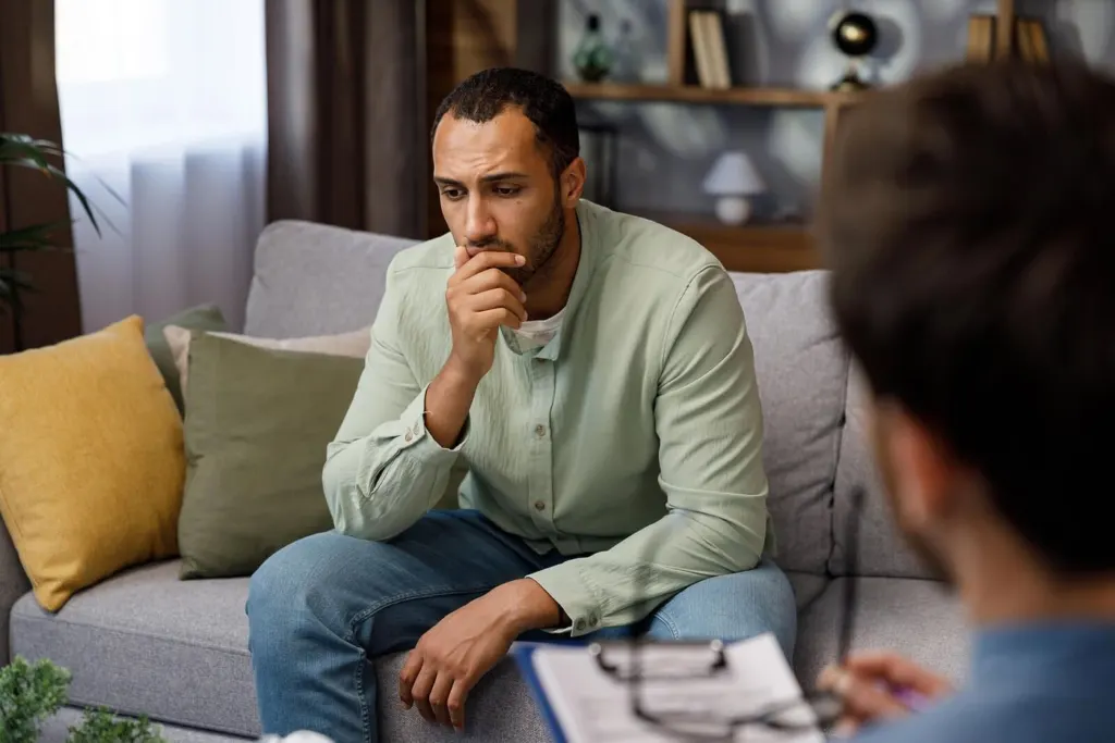 A man holding his chin while talking to a grief therapist | grief counselor san francisco | grief counseling san francisco, ca | grief therapy in san francisco, ca |  94608 | 94609 | 94061