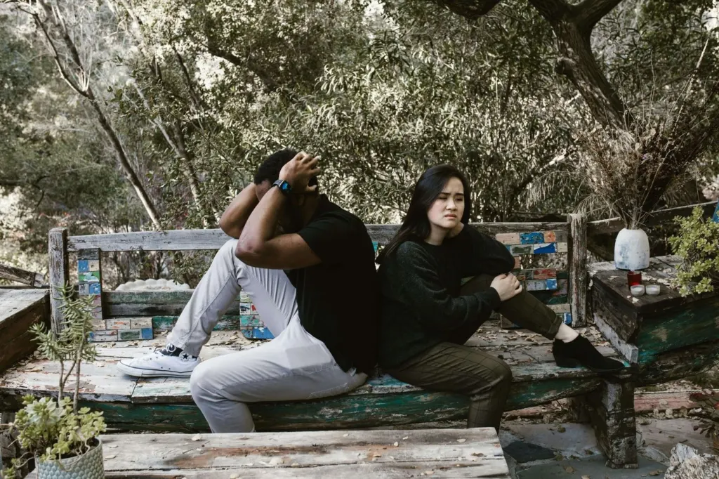 A couple in a disagreement sitting on a bench | men's therapy san francisco, ca | men's counseling san francisco, ca | online men's issues counseling california | 94607 | 94608 | 94609